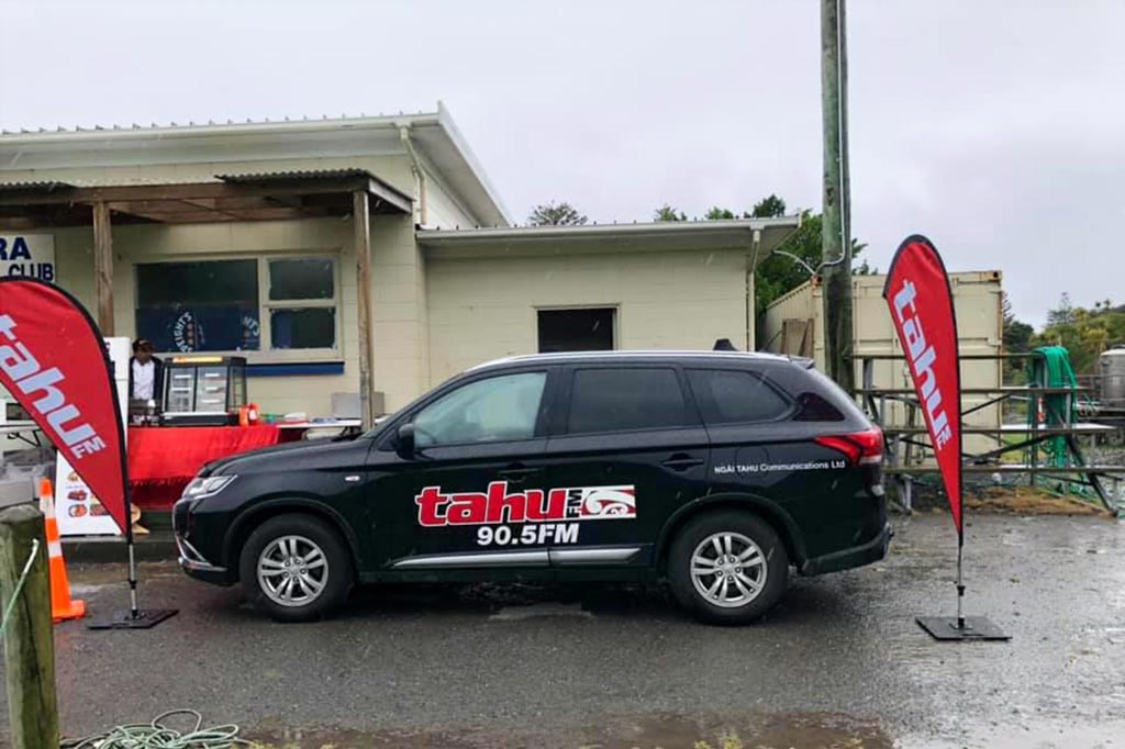 Car with Tahu radio branding at a community event