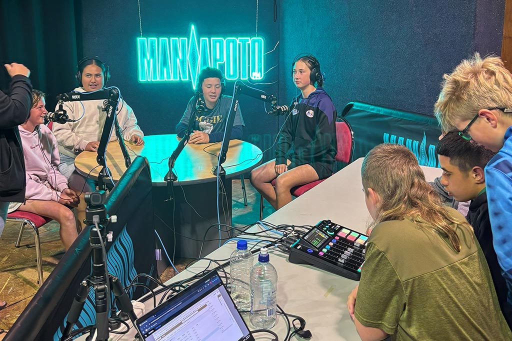 Group of school students broadcasting in the studio at Maniapoto FM